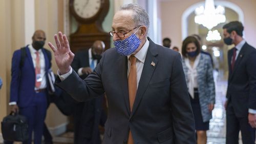 On the first full day of Democratic control, Senate Majority Leader Chuck Schumer, D-N.Y., walks to the chamber after meeting with new senators from his caucus, at the Capitol in Washington, Thursday, Jan. 21, 2021.