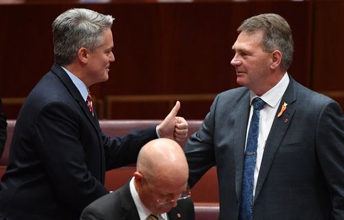 Minister for Finance Mathias Cormann congratulating Steven Martin after he delivered his maiden speech to Parliament in March. Picture: AAP