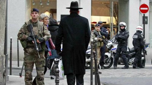 Police officers and French army soldiers patrol Rue des Rosiers street, in the heart of Paris Jewish quarter. (AP)