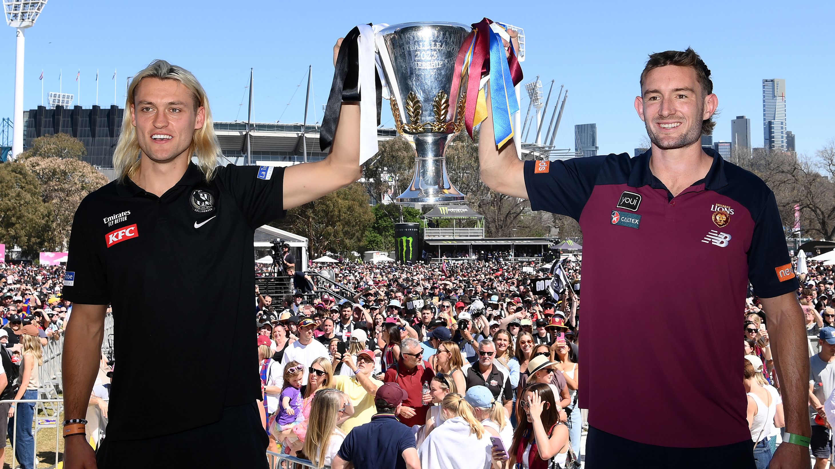 Darcy Moore of the Magpies and Harris Andrews of the Lions hold aloft the 2023 Premiership Cup.