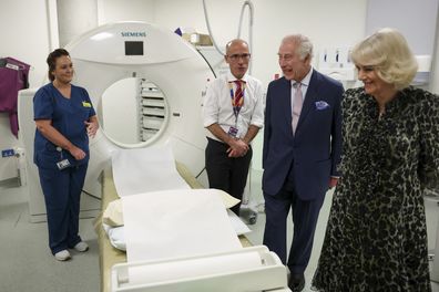 King Charles III and Queen Camilla look at the CT scanner next to Cancer Research UK's Chief Clinician, Charlie Swanton during a visit to the University College Hospital Macmillan Cancer Centre in London, Tuesday April 30, 2024. 