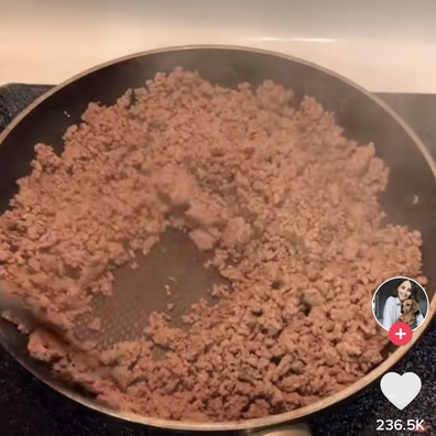 Woman washes cooked meat