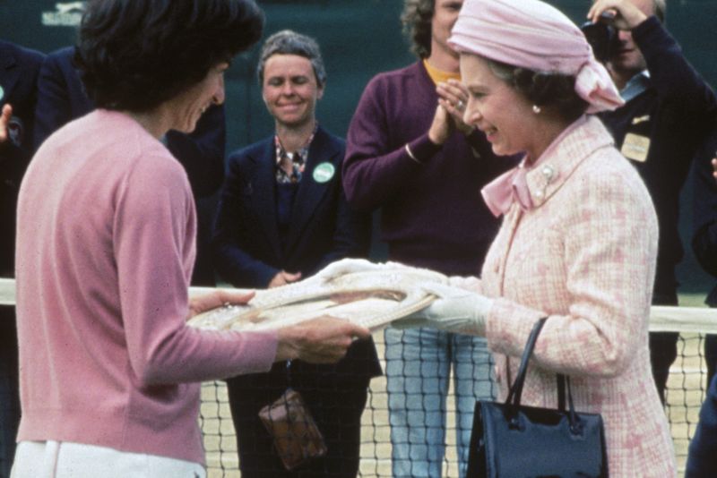 Queen Elizabeth II presents the trophy to British tennis player Virginia Wade after she won the Women&#x27;s Singles competition at Wimbledon, 1st July 1977.  (Photo by Hulton Archive/Getty Images)