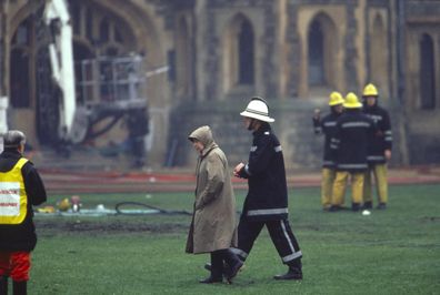 Queen Elizabeth inspects the damage at Windsor Castle after November 1992 fire