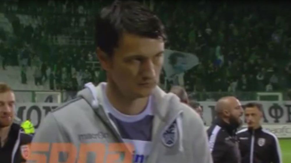 Beer can hits PAOK manager Vladan Ivic during Greek playoff against Panathinaikos