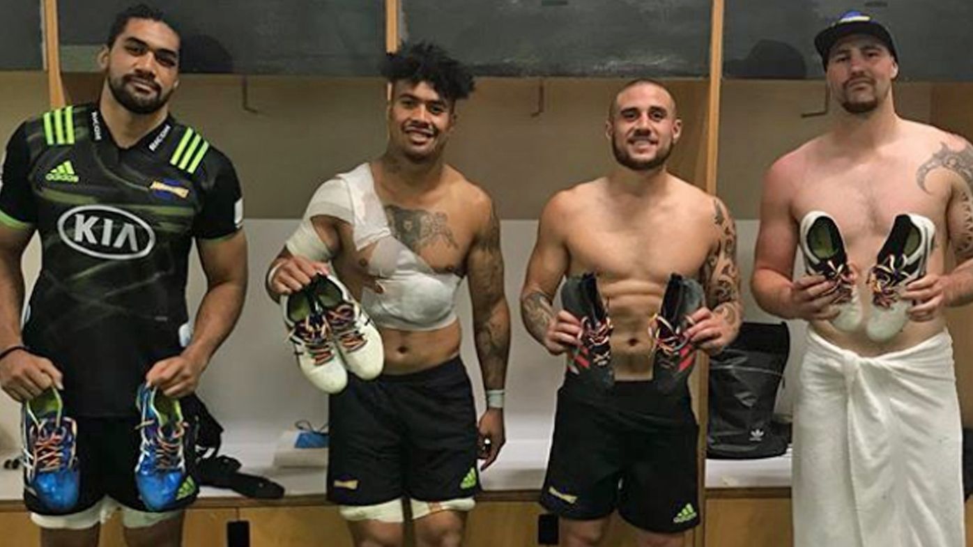 Hurricanes players hold up heir rainbow laces