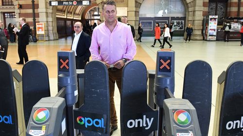 NSW Minister for Transport and Infrastructure Andrew Constance goes through an Opal Card turnstile after a press conference at Central Station