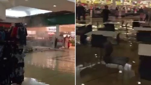 Sydney shopping centre evacuated as water gushes through ceiling