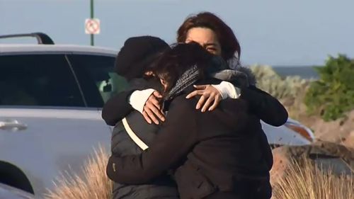 Family gathered at Altona were devastated to learn all three men died after their boat capsized. (9NEWS)