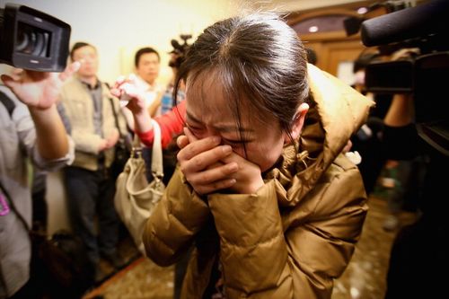  A relative of a passenger onboard Malaysia Airlines flight MH370 cries out. (Getty)