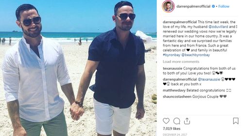 A photo of Darren Palmer and his husband Olivier Duvillard in Byron Bay renewing their marriage vows.
