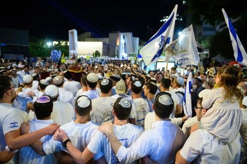 Israel has received a coffin carrying the body of a deceased hostage, the prime minister's office said in a statement late Friday. In this October 14 photo, people celebrated in Tel Aviv's Hostages Square after the announcement that bodies of four Israeli hostages would be released.