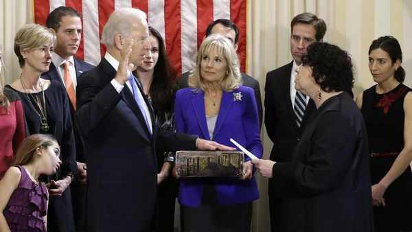 Joe Biden takes the oath of office alongside Kathleen and Hunter Biden, far left, and Beau and Hallie Biden, far right. (AAP)