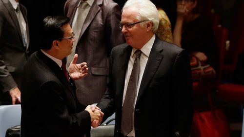 The Malaysian transport minister, Dato Sri Liow Tiong Lai, shakes hands with Vitaly Churkin, the Russian ambassador. (AAP)