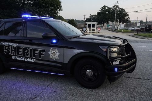 A Sheriff's vehicle patrols outside the Fulton County Jail, Thursday, Aug. 24, 2023, in Atlanta. 