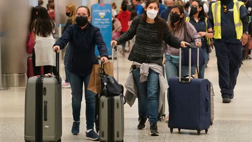 International travel is resuming. Passengers are seen here rushing to check-in their luggage at the Miami International Airport. 