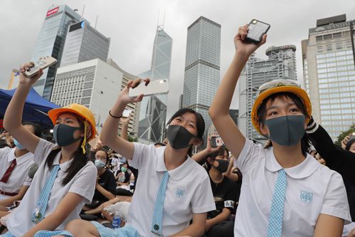 Students wear helmets and face masks during a protest in Hong Kong, on Monday, Sept. 2, 2019.  (AP Photo/Kin Cheung)