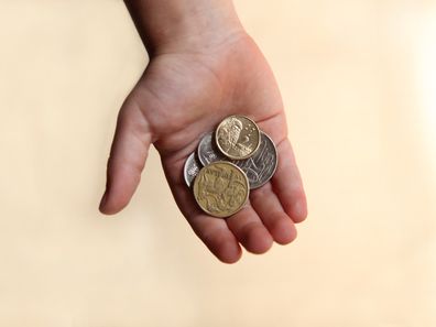 A boy holding Australian Money