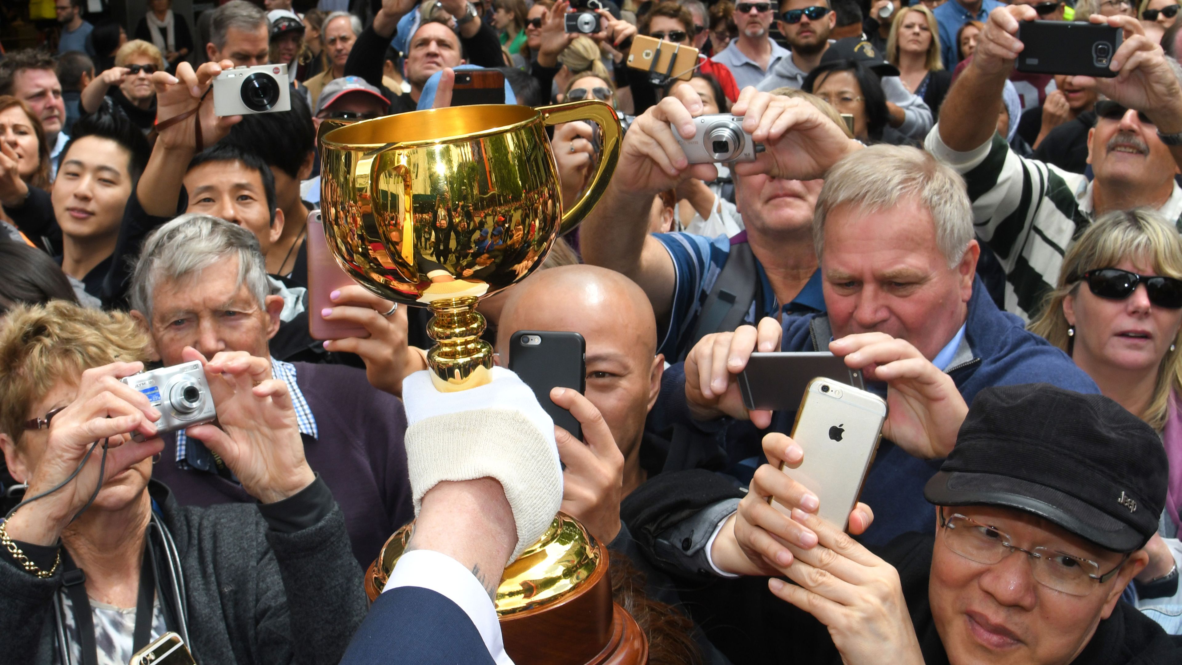 The Melbourne Cup is held into the crowd for fans to take pictures during the 2016 Melbourne Cup Parade on October 31, 2016 in Melbourne, Australia. 