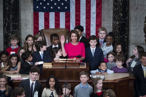 Democratic Speaker of the House Nancy Pelosi, surrounded by her grandchildren and the children of other lawmakers.