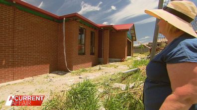 Kerry Reid's brickwork is finally up on her house, but she is still a long way from moving in.