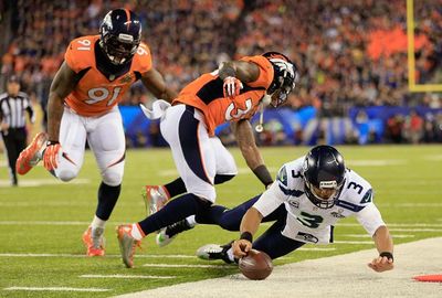 Seattle quarterback Russell Wilson tried in vain to keep their first drive alive.