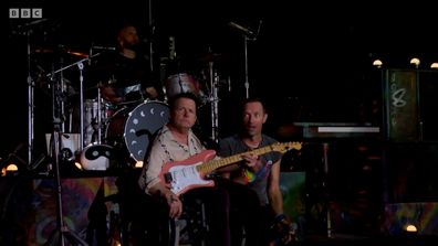 Michael J. Fox performs with Coldplay at Glastonbury.