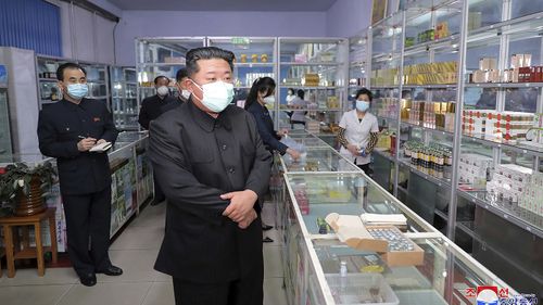 Kim Jong-un visits a pharmacy in Pyongyang in May.