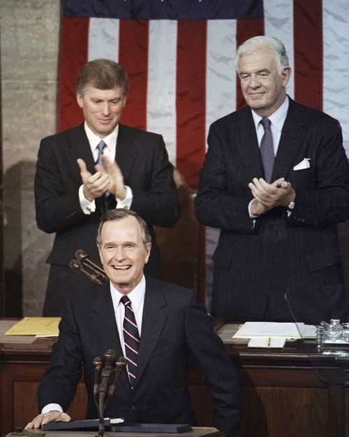 President George H.W. Bush receives applause from Vice President Dan Quayle, left, and House Speaker Thomas Foley prior to delivering his first State of the Union address on Capitol Hill in Washington in 1990.
