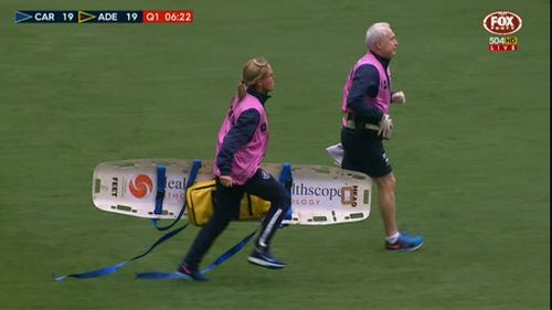 Medics run onto the pitch. (9NEWS)