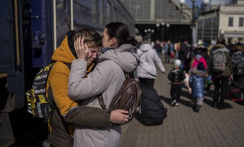 A mother embraces her son who escaped the besieged city of Mariupol and arrived at the train station in Lviv, western Ukraine.