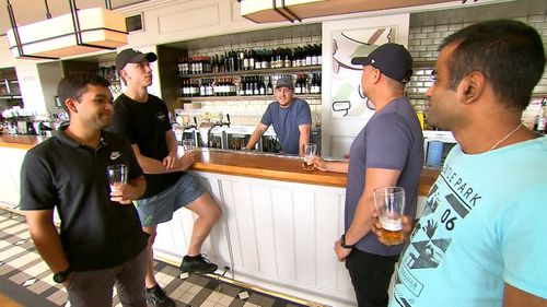 A barman watches as patrons in a Sydney pub drink their final beers before the coronavirus lockdown began on Monday.