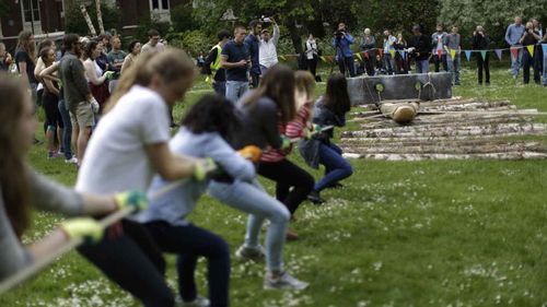 Volunteers heave a one-tonne rock during a University College London experiment. (AP)