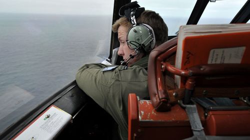 Flying Officer Benjamin Hepworth searches from a Royal Australian Airforce AP-3C Orion for possible MH370 debris. (Getty)
