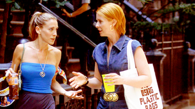 Carrie and Miranda talking and walking down the street in Sex and the City.