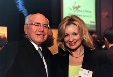 Meeting former Prime Minister John Howard at a corporate event.