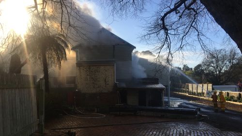 More than 50 firefighters are still battling the fire, and there are concerns the property could contain asbestos. 