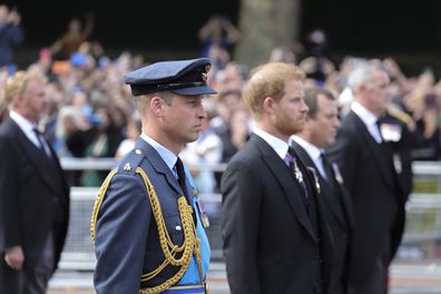 Prince William, Prince of Wales and Prince Harry, Duke of Sussex walk behind the coffin during the procession for the Lying-in State of Queen Elizabeth II on September 14, 2022 in London, England. Queen Elizabeth II's coffin is taken in procession on a Gun Carriage of The King's Troop Royal Horse Artillery from Buckingham Palace to Westminster Hall where she will lay in state until the early morning of her funeral. Queen Elizabeth II died at Balmoral Castle in Sco