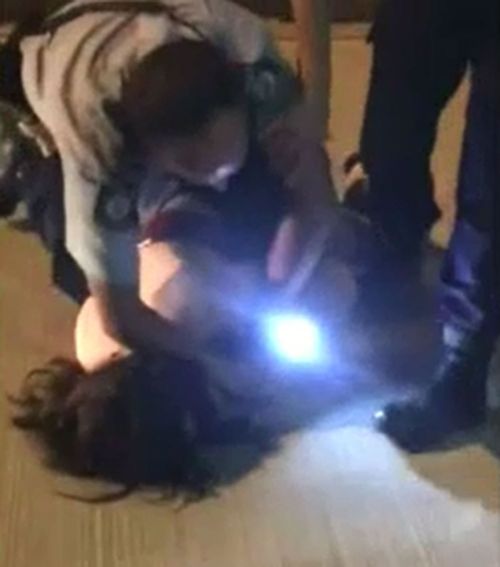 A 15-year-old girl was wrestled to the ground by police. (9NEWS)