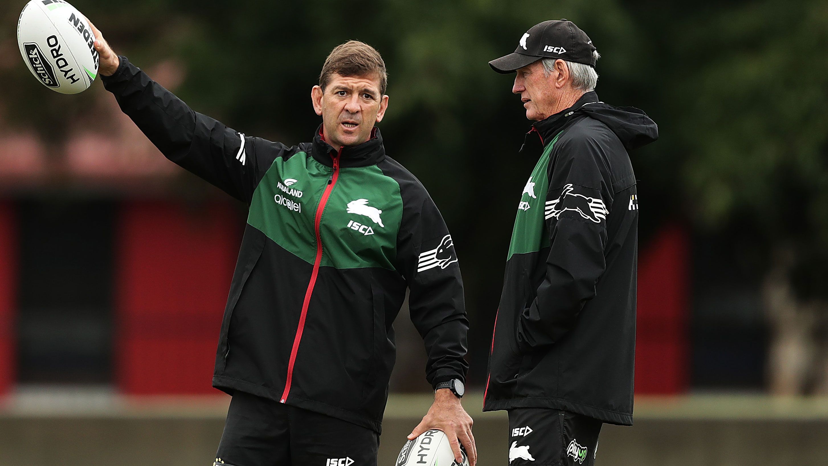 Then Rabbbitohs assistant coach Jason Demetriou talks to Wayne Bennett during a training session at Redfern Oval in 2020.