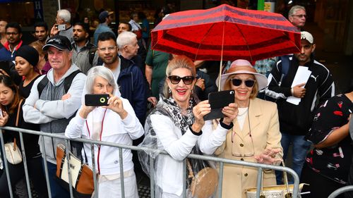 People line the streets to watch the excitement of the Melbourne Cup Parade.