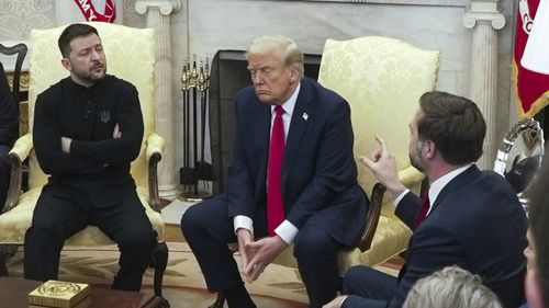 FILE - U.S. Vice President JD Vance, right, speaks with Ukrainian President Volodymyr Zelenskyy, left, as President Donald Trump listens, in the Oval Office at the White House on Feb. 28, 2025, in Washington. (AP Photo/ Mystyslav Chernov, File)