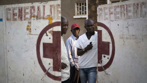 Employees guard the door of the Katuba Reference Hospital in Lubumbashi, Democratic Republic of the Congo.