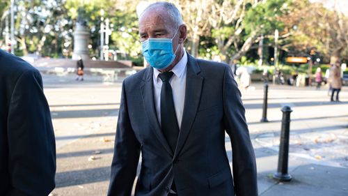 Chris Dawson (blue mask) arrives at Supreme Court on Monday June 27.