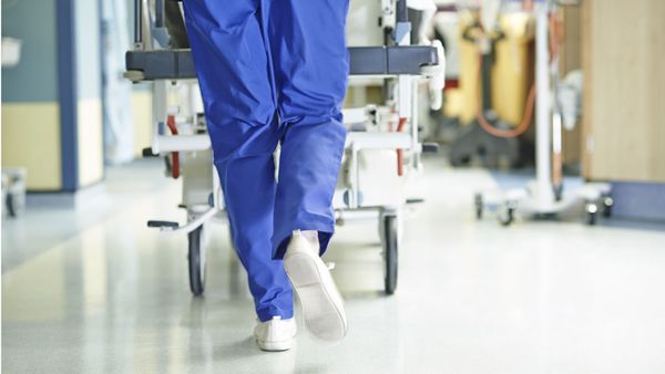 Woman pushing trolley in hospital