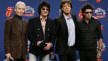 Members of the Rolling Stones, from left, drummer Charlie Watts, guitarist Ron Wood, singer Mick Jagger, and guitarist Keith Richards. pose for photographers after arriving for a Super Bowl news conference in Detroit on Feb. 2, 2006.