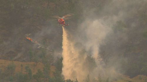 An out-of-control bushfire west of Ballarat will still be burning when Victoria is hit by a combination of wind and heat not seen in years. 