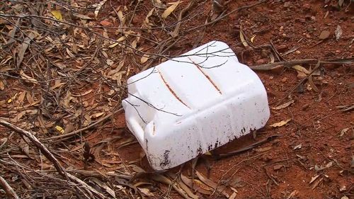 An empty water container was found near his car.