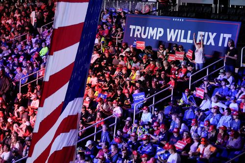 Donald Trump supporters and the sign "Trump will fix it".