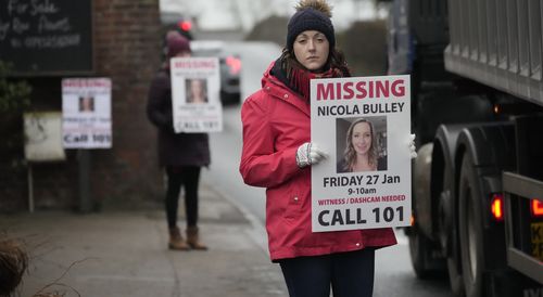 People line the streets with placards asking for information on missing Nicola Bulley in the village of St Michael's on Wyre on February 10, 2023 in Preston, England.